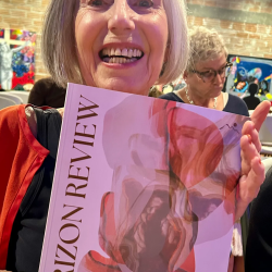 Rose Marie Prins holding a copy of the first edition of "The Horizon Review"